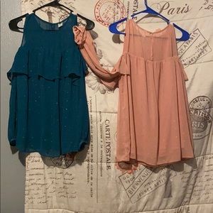 two dress shirts a sweater and a summer crop top